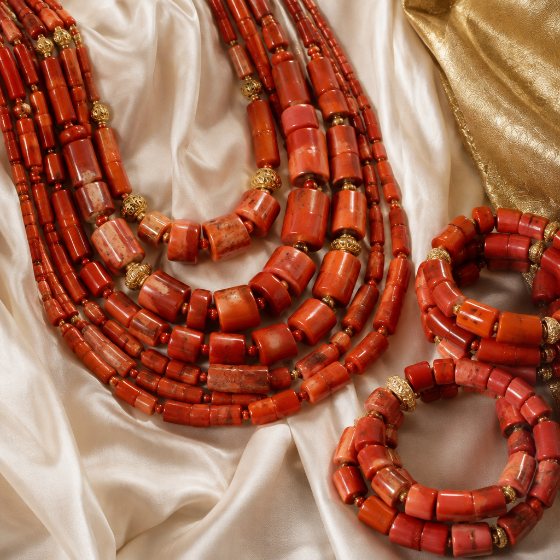 Coral bead necklaces on ivory silk